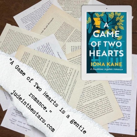On a backdrop of book pages, an iPad with the cover of A Game of Two Hearts by Iona Kane. At the bottom of the image, on the left-hand side, a strip of torn paper with a quote: "A Game of Two Hearts is a gentle romance" and a url: judeinthestars.com