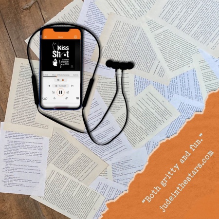 On a backdrop of book pages, an iPhone with the cover of Kiss Shot by Carolyn Elizabeth, narrated by Amy Deuchler. In the bottom right corner of the image, a strip of torn paper with a quote: "Both gritty and fun." and a URL: judeinthestars.com.