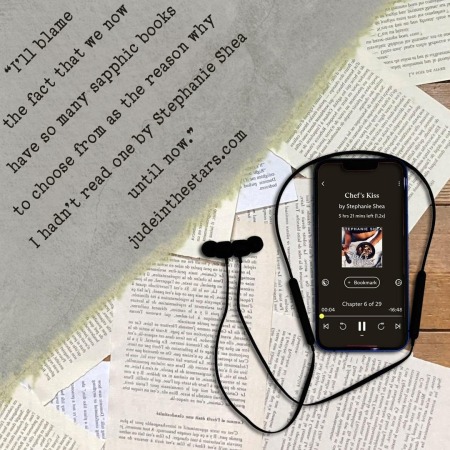 On a backdrop of book pages, an iPhone with the cover of Chef's Kiss by Stephanie Shea, narrated by AJ Ferraro. In the top left corner of the image, a strip of torn paper with a quote: "I’ll blame the fact that we now have so many sapphic books to choose from as the reason why I hadn’t read one by Stephanie Shea until now." and a URL: judeinthestars.com.